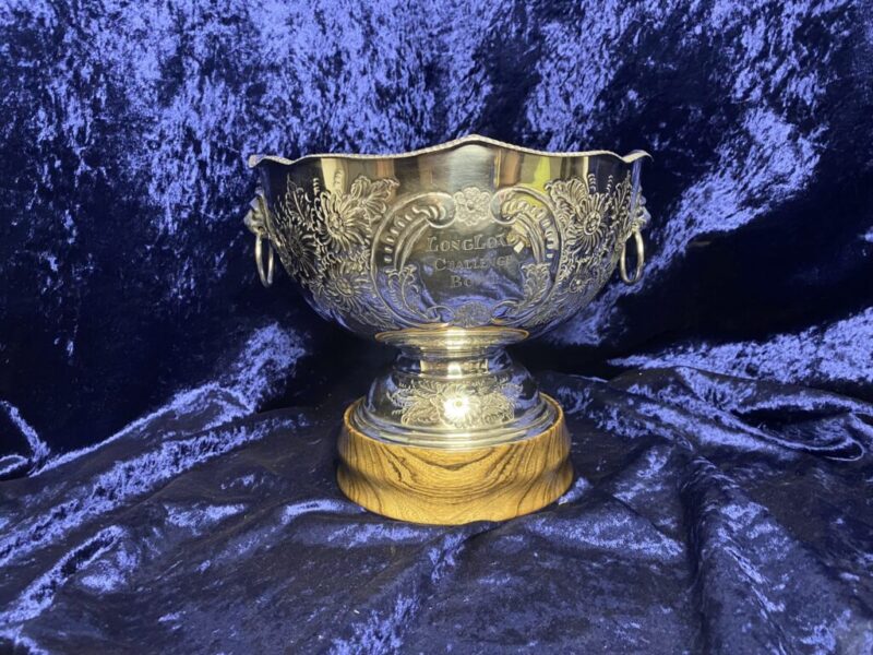 gold metal trophy on wooden stand